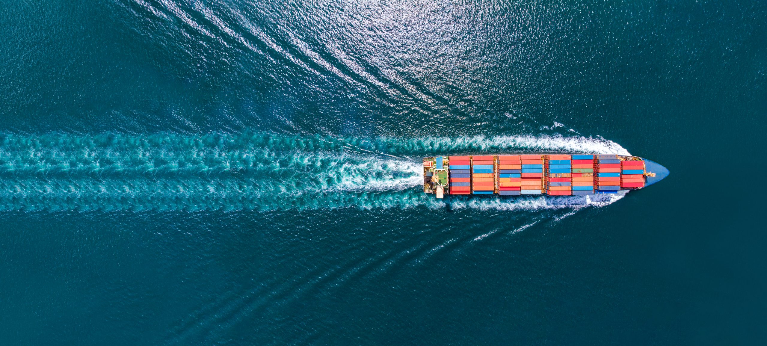Webinar-banner-aerial-top-view-of-cargo-maritime-ship-with-contrail-in-the-ocean-ship-carrying